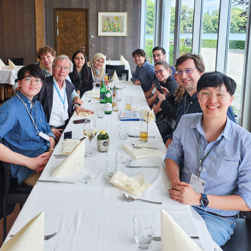 Senica, Hänsch and others sitting around a table for a meal