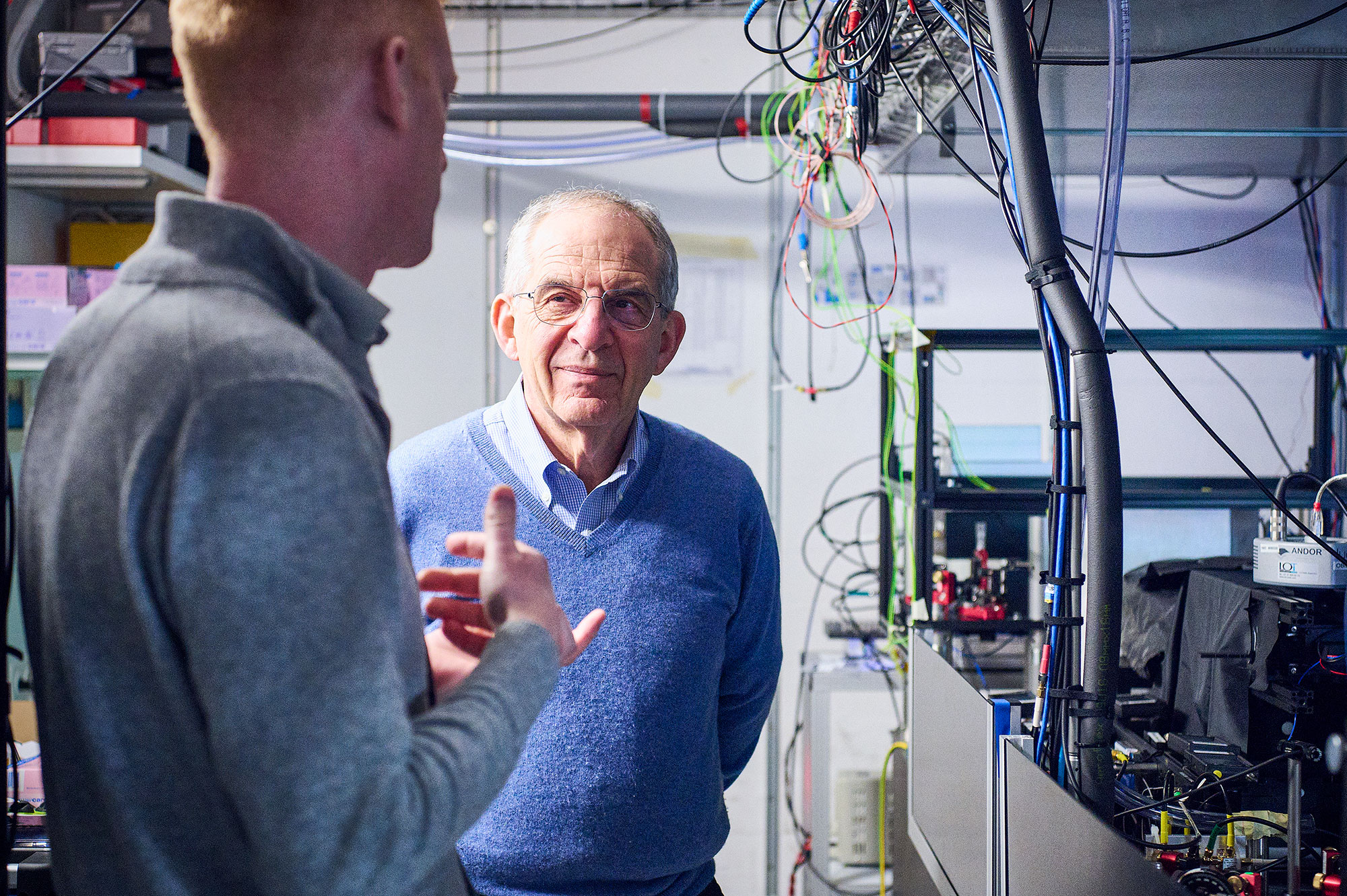 Jonathan Home and Michel Devoret talking in Home's laboratory